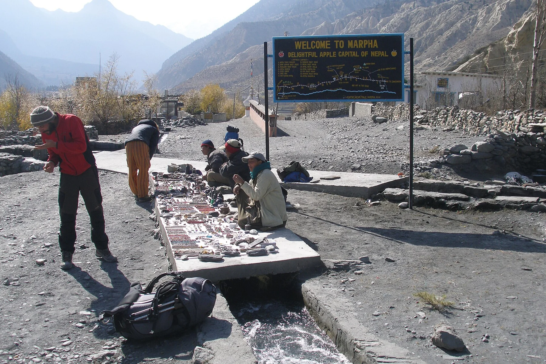 A village street with a welcome sign in Marpha in the Kali Gandaki valley