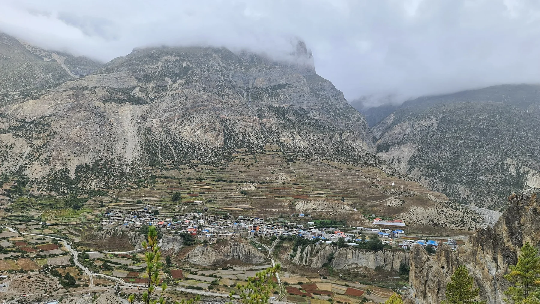 Manang town sits beneath broad rocky slopes in the northern Annapurna region